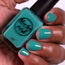 Load image into Gallery viewer, Blue Green nail polish swatch on medium deep skin tone