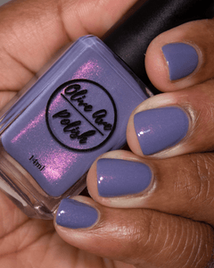 Purple shimmer nail polish swatch on medium dark skin tone