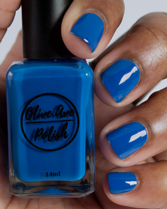 royal blue nail polish swatch on medium skin tone
