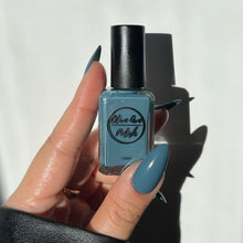 Load image into Gallery viewer, Dusty cerulean blue nail polish swatch on pale skin