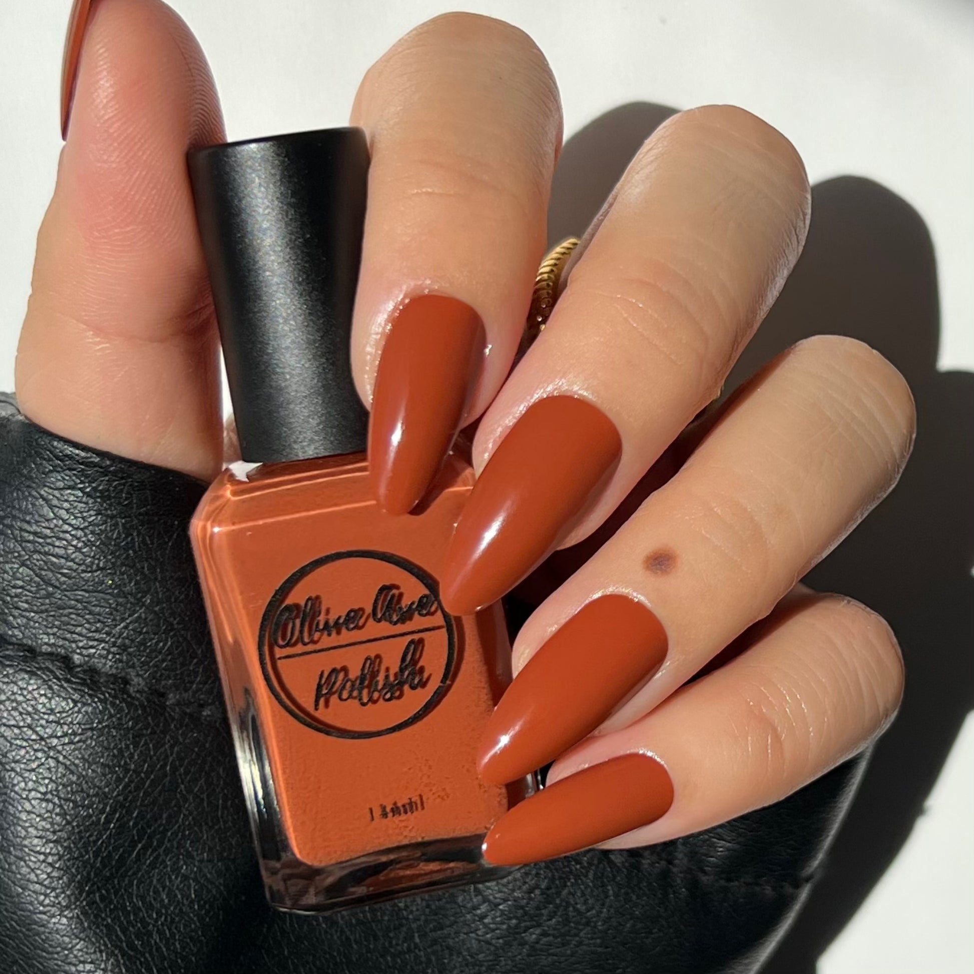 Fall orange nail polish swatch on pale skin tone