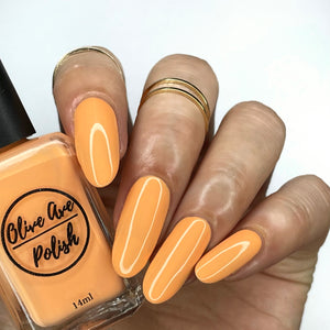 Creamsicle Orange nail polish swatch on medium skin tone