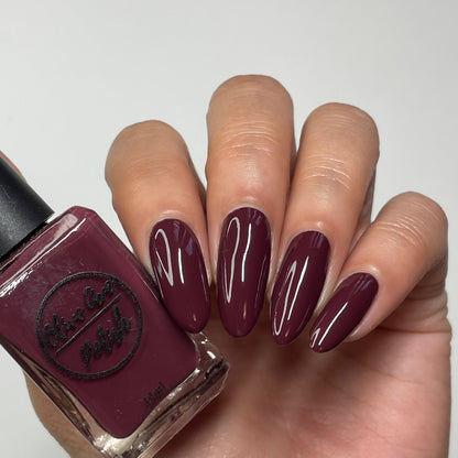 Burgundy wine nail polish swatch on pale skin tone