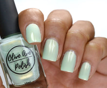 Load image into Gallery viewer, Spring green nail polish on medium skin tone