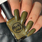 Green holographic nail polish swatch on pale skin tone
