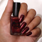 burgundy nail polish with gold shimmer swatch on pale skin tone