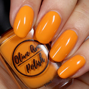 bright orange nail polish swatch on pale skin tone