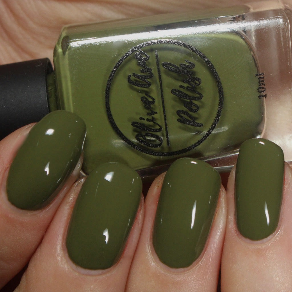 olive green nail polish swatch on pale skin tone