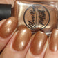 Bronze nail polish on pale skin tone
