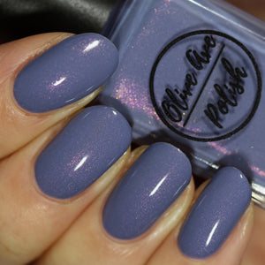 Purple shimmer nail polish swatch on pale skin tone