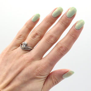 Spring green nail polish on pale skin tone