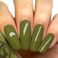 olive green nail polish swatch on pale skin tone
