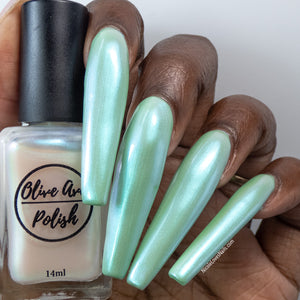 White pearl nail polish swatch on deep skin tone