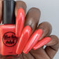 coral shimmer nail polish swatch on deep skin tone