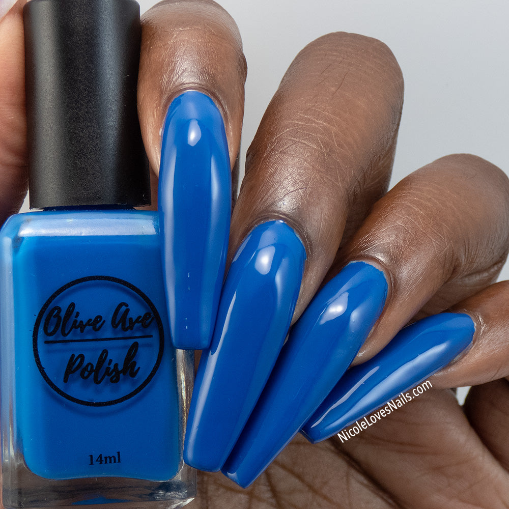royal blue nail polish swatch on deep skin tone