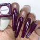 wine red nail polish swatch on deep skin tone