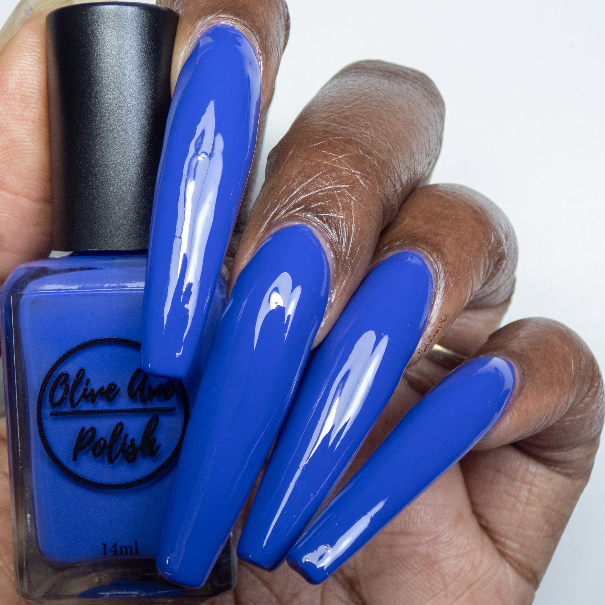 blue purple nail polish swatch on deep skin tone