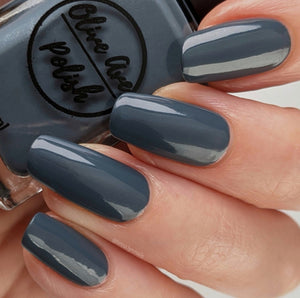 blue grey nail polish swatch on pale skin tone