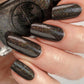 brown holographic nail polish swatch on pale skin tone