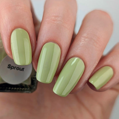 light green nail polish swatch on pale skin tone