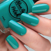 Load image into Gallery viewer, Blue Green nail polish swatch on pale skin tone