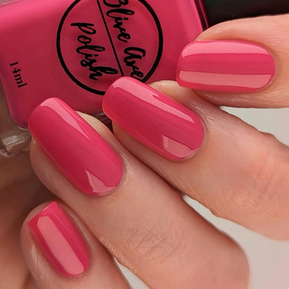 bright pink nail polish swatch on pale skin tone