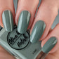 sage green nail polish swatch on pale skin tone