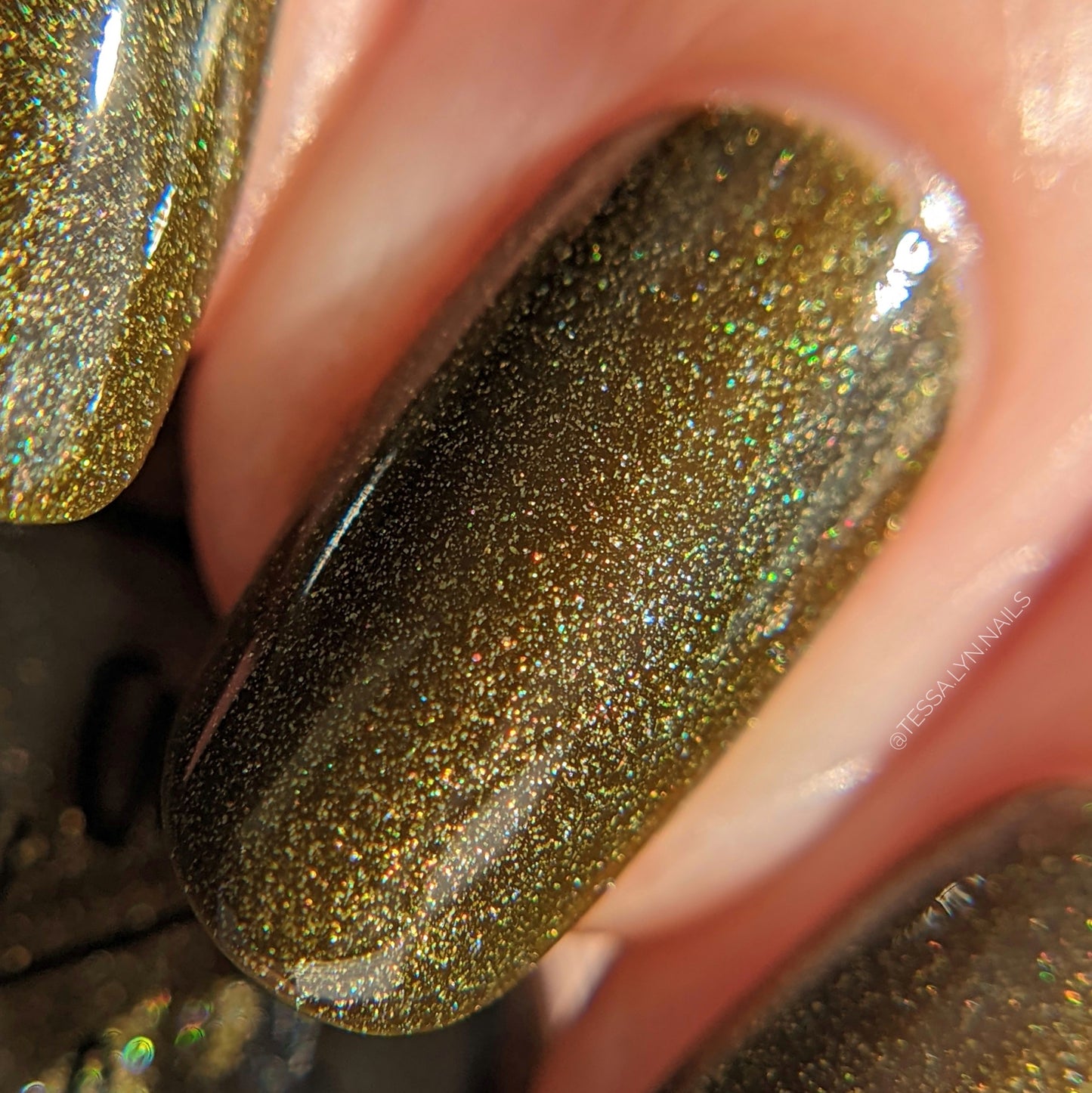 Green holographic nail polish swatch on pale skin tone