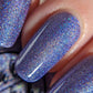 Purple holographic nail polish swatch on pale skin tone