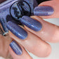 Purple holographic nail polish swatch on pale skin tone