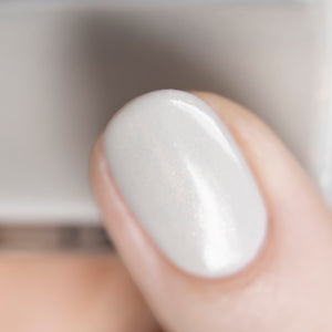 grey shimmer nail polish swatch on pale skin tone