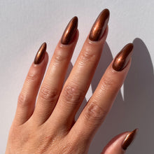 Load image into Gallery viewer, metallic brown nail polish swatch on pale skin tone