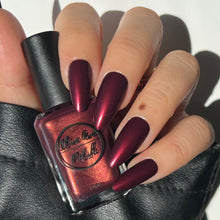 Load image into Gallery viewer, burgundy nail polish with gold shimmer swatch on pale skin tone