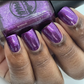 purple metallic nail polish swatch on medium deep skin tone