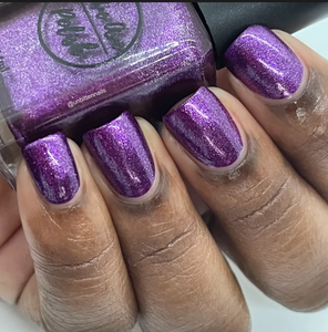 purple metallic nail polish swatch on medium deep skin tone