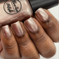 rose gold nail polish swatch on medium deep skin tone