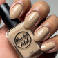 Tan nude nail polish swatch on medium skin tone