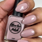 Shimmery taupe nail polish swatch on medium skin tone