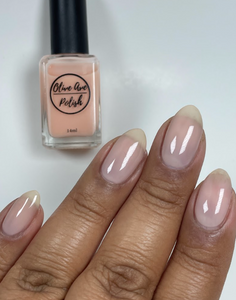 Sheer nude nail polish swatch on medium dark skin tone