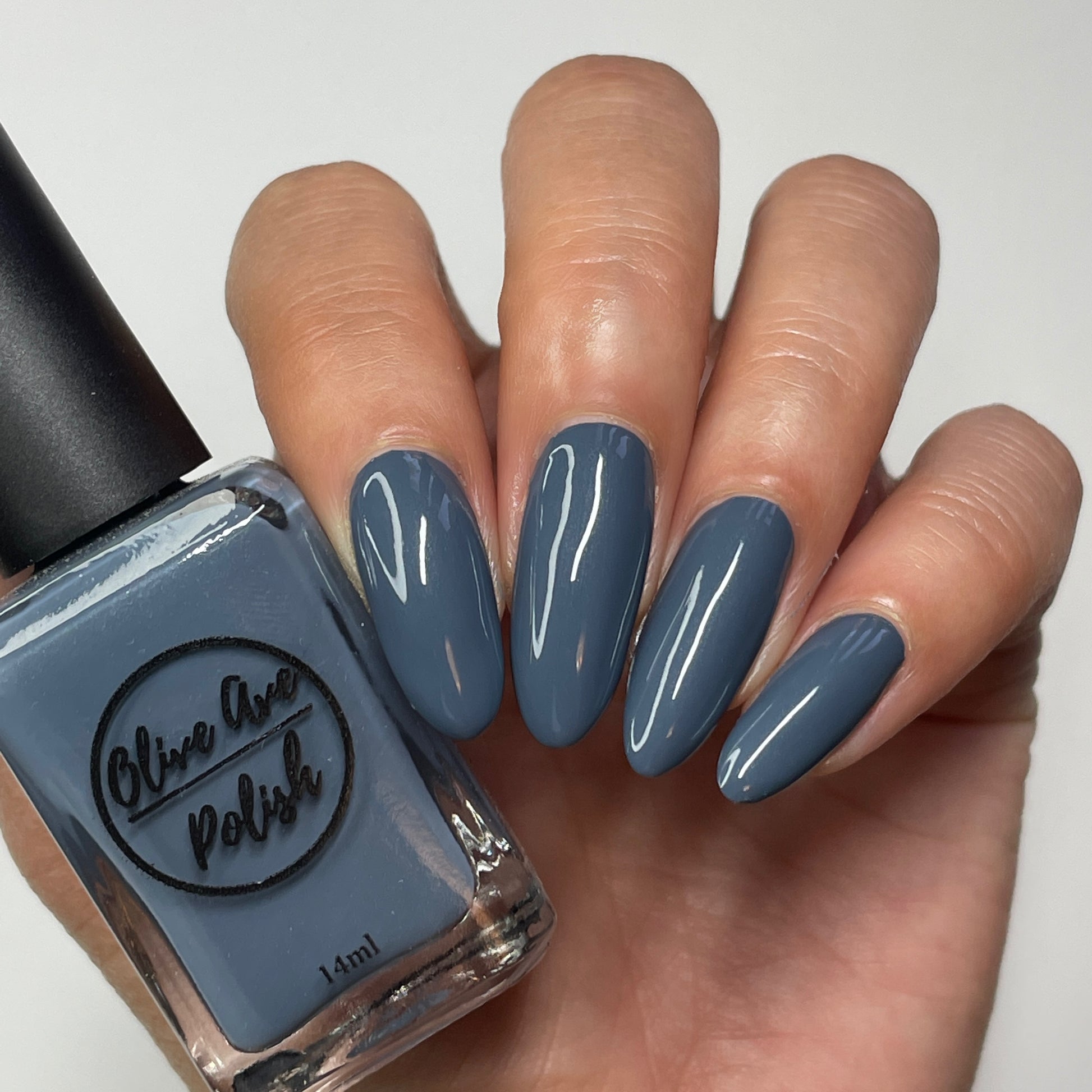 blue grey nail polish swatch on pale skin tone
