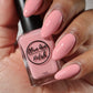 pastel coral nail polish swatch on medium skin tone