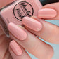 pastel coral nail polish swatch on pale skin tone