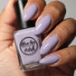 purple grey nail polish swatch on medium skin tone