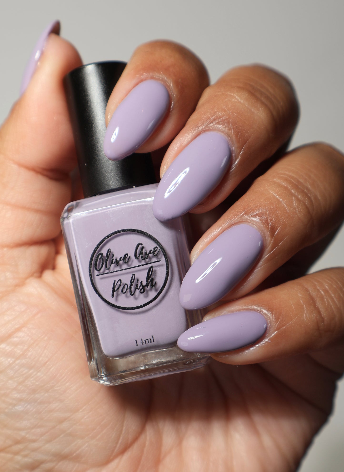 purple grey nail polish swatch on medium skin tone