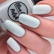 Load image into Gallery viewer, Light sky blue cream nail polish swatch on pale skin tone