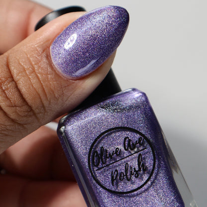 Purple holographic nail polish swatch on pale skin tone