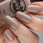 Shimmery taupe nail polish swatch on pale skin tone