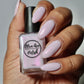 Light purple shimmer nail polish swatch on medium skin tone