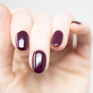 wine red nail polish swatch on pale skin tone