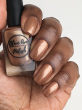 Load image into Gallery viewer, Bronze nail polish swatch on medium dark skin tone